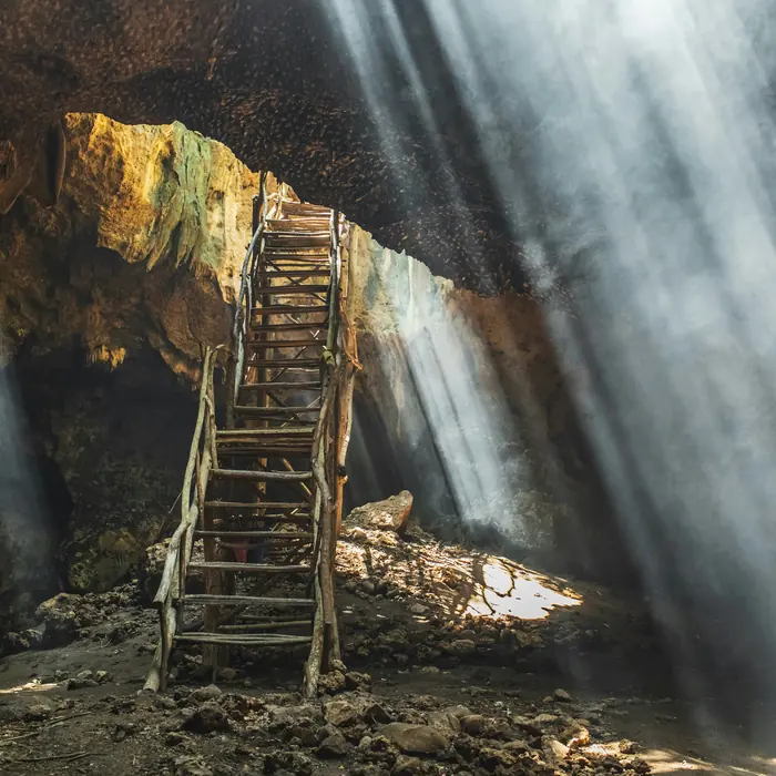 Shafts of daylight falling into a cave