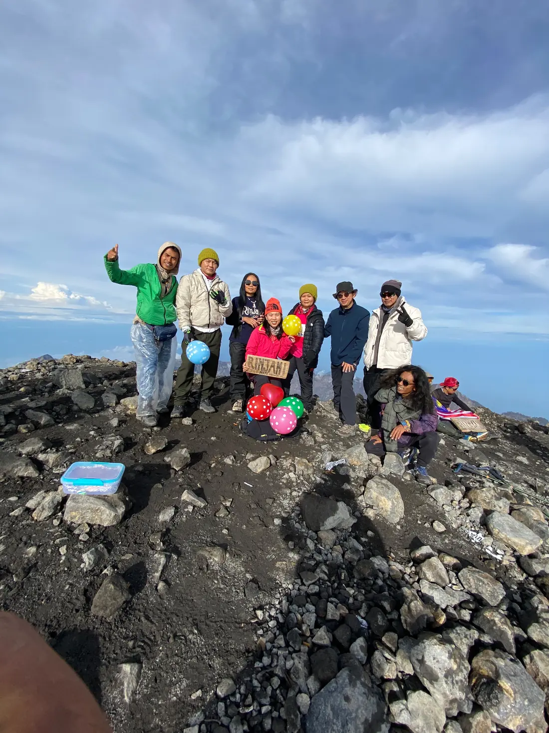 Trekking group celebrating at the 3,726 m summit of Mount Rinjani